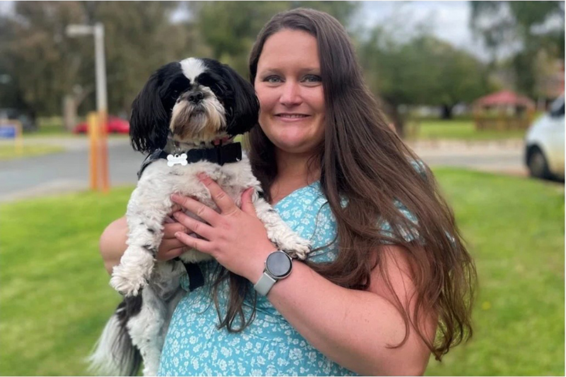 Lady holding a small dog